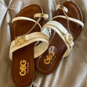 White g sandals with gold accents